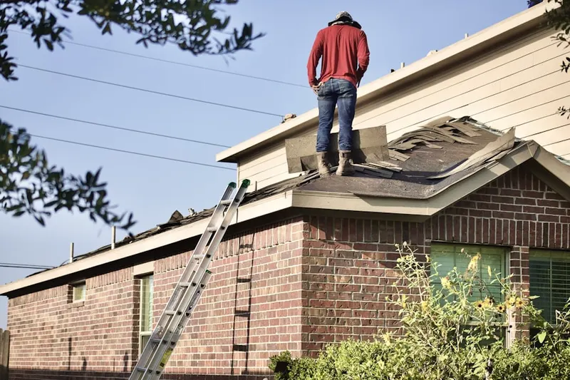 Professional roofer working on a residential roof in Oyster Bay